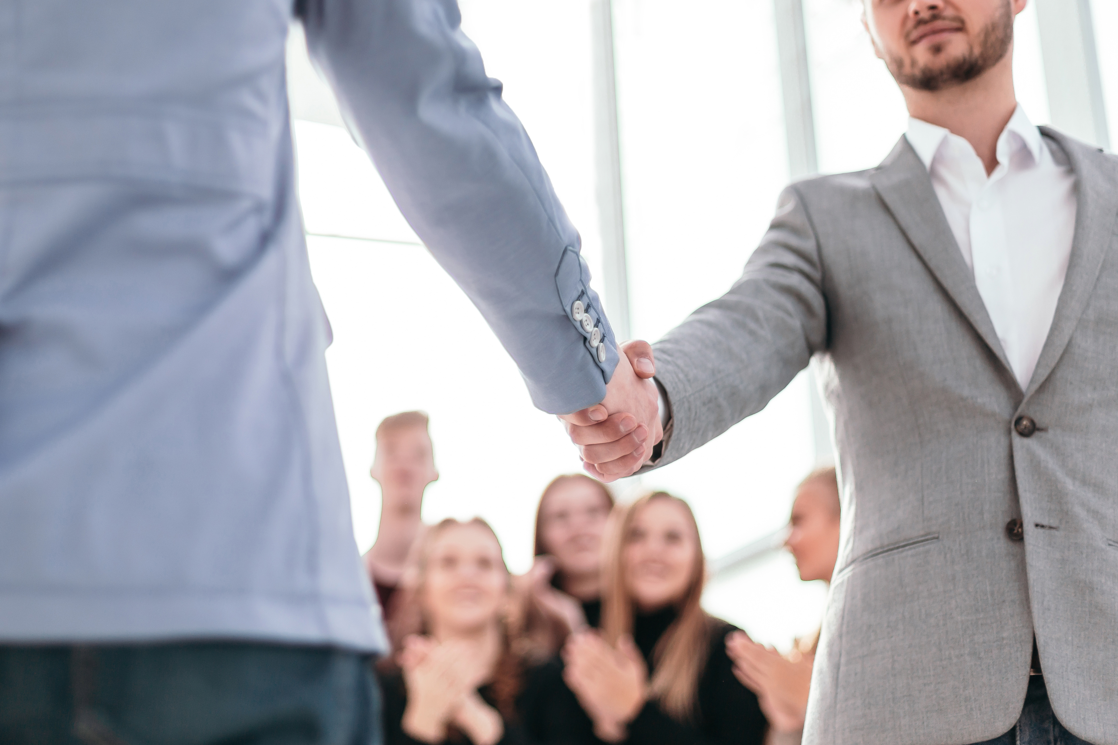 Close Up Confident Young Business Partners Meet Each Other With Handshake