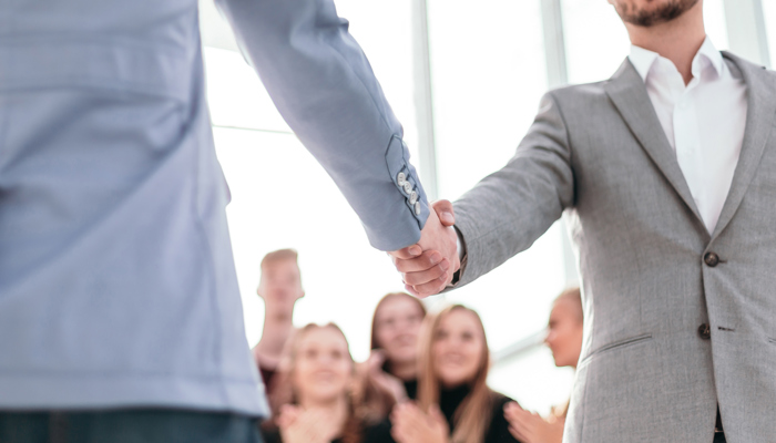 Close Up Confident Young Business Partners Meet Each Other With Handshake